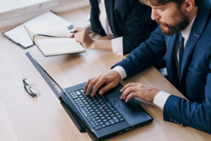 managers-sitting-at-a-desk-with-a-laptop-communication-finance-officials-1024x683 - Lapto Portal